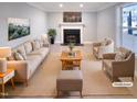 This virtually staged living room features a fireplace, neutral decor, and cozy seating arrangement at 101 Madeline Ct, Youngsville, NC 27596