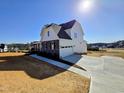 Spacious home with a large driveway, two-car garage, and well-manicured lawn at 1021 Prominence Dr., Homesite 20, Durham, NC 27712