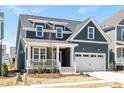 Inviting home with a covered porch, two-car garage, and a well-maintained yard at 1205 Porters Call Dr, Wendell, NC 27591