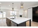 Modern kitchen features a large island with white countertop and stylish pendant lighting at 1205 Porters Call Dr, Wendell, NC 27591