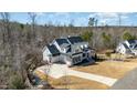 Aerial view of a large home with a long driveway and three car garage at 175 Stonecrest Way, Pittsboro, NC 27312