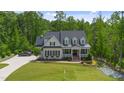 A beautiful home with a manicured lawn, a car in the driveway and beautiful landscaping at 175 Stonecrest Way, Pittsboro, NC 27312