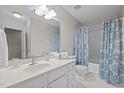 Bright bathroom features a shower-tub combo with patterned blue curtain and spacious vanity at 2268 Plum Frost Dr, Raleigh, NC 27603