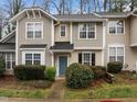 Inviting townhouse with beautiful landscaping, a blue front door, and neutral siding at 2268 Plum Frost Dr, Raleigh, NC 27603