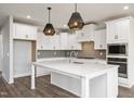 Bright kitchen featuring white cabinetry, a large center island, and modern appliances at 264 Big Bradley Dr, Wendell, NC 27591