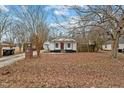 Cozy white cottage with a brick mailbox and long driveway at 308 Williamson St, Burlington, NC 27215