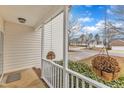 View from the porch, showing hanging planters and a glimpse of the neighborhood street at 309 Amaryllis Way, Wake Forest, NC 27587