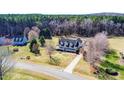 Scenic aerial view of a house with a long driveway and surrounded by lush greenery at 3337 Scarlet Oak Dr, Mebane, NC 27302