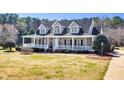 Inviting two-story home featuring a classic facade, covered porch, and landscaped front yard at 3337 Scarlet Oak Dr, Mebane, NC 27302