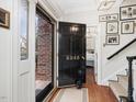 Welcoming entryway featuring a black front door with gold number, hardwood floors, and staircase at 3343 Ridgecrest Ct, Raleigh, NC 27607