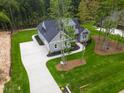 New construction home featuring a landscaped yard, long driveway, and gray siding at 3909 Cedar Knolls Dr # 6, Youngsville, NC 27596