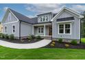 Charming new construction home with meticulous landscaping, gray siding, and stylish architecture at 3909 Cedar Knolls Dr # 6, Youngsville, NC 27596