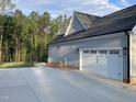 Home exterior with gray siding and a two-car garage at 3909 Cedar Knolls Dr # 6, Youngsville, NC 27596