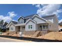 Beautiful two-story home showcasing modern architectural design with brick foundation and unfinished landscaping at 3928 Willow Gate Way, Raleigh, NC 27604
