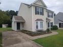 Side view of a well-maintained two-story home with neutral siding, clean driveway, and landscaped flowerbed at 711 Weathervane Way, Rocky Mount, NC 27803