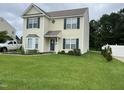 Inviting two-story home featuring a green lawn, charming curb appeal, and attractive shutters at 711 Weathervane Way, Rocky Mount, NC 27803