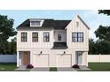 A symmetrical home showcasing a double front elevation, modern design, two-car garages, and beautiful landscaping at 925 Selby Ave, Durham, NC 27713