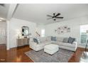 Spacious living room featuring hardwood floors, a large sectional sofa, and stylish decor at 1005 Forest Willow Ln, Morrisville, NC 27560