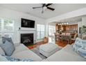 Bright living room with a cozy fireplace, hardwood floors, and comfortable seating near the open kitchen at 1005 Forest Willow Ln, Morrisville, NC 27560