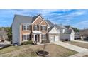 A charming, partially-viewed two-story home with a brick facade and a well-manicured lawn at 101 Rock River Rd, Morrisville, NC 27560