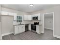 Modern kitchen featuring stainless steel appliances, white cabinets, and granite countertops at 1012 E Harnett St, Dunn, NC 28334