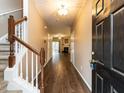 Inviting entryway with hardwood floors, staircase, and view of the living area at 102 Forrymast Trl, Apex, NC 27539