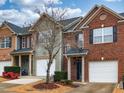 A row of townhomes showcasing varied architectural styles, with manicured lawns at 102 Forrymast Trl, Apex, NC 27539