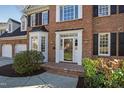 Elegant brick home showcasing a refined entrance with a bay window and detailed trim at 102 Seabreeze Ct, Cary, NC 27513