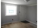A room featuring a window, a door, light gray walls and a brown carpet at 106 W Allen St, Four Oaks, NC 27524