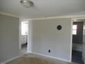 A room featuring light gray walls and a window view to a kitchen at 106 W Allen St, Four Oaks, NC 27524