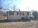 Back of a single story home featuring a door with steps and a small tree at 106 W Allen St, Four Oaks, NC 27524