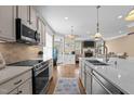 Kitchen island features quartz countertops and a sink with views into the living area at 1117 Golden Star Way, Wake Forest, NC 27587