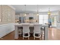 Bright kitchen with a large center island, seating, and stainless steel appliances at 1117 Golden Star Way, Wake Forest, NC 27587