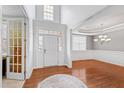Bright foyer with hardwood floors, transom windows, and elegant chandelier showcasing open concept design at 1122 Virginia Water Dr, Rolesville, NC 27571