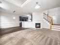 Bright and airy living room with a fireplace, staircase, and hardwood flooring at 1213 Red Beech Ct, Raleigh, NC 27614