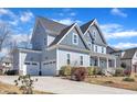 Lovely two-story home with a three-car garage, driveway, and charming curb appeal at 1421 Sweetclover Dr, Wake Forest, NC 27587