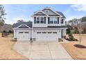 Charming two-story home featuring a two car garage, landscaped yard, and neutral colored siding at 176 E Ravano Dr, Clayton, NC 27527