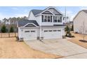 Charming two-story home featuring a two car garage, landscaped yard, and neutral colored siding at 176 E Ravano Dr, Clayton, NC 27527