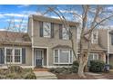 Charming townhouse featuring neutral siding, blue shutters, and a well-manicured front yard at 2 Forest Green Dr, Durham, NC 27705