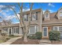 Charming townhouse featuring neutral siding, blue shutters, and a well-manicured front yard at 2 Forest Green Dr, Durham, NC 27705
