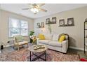 Cozy living room featuring neutral tones, a ceiling fan, and comfortable seating, perfect for relaxing and entertaining at 2305 Fitzgerald Ave, Durham, NC 27707