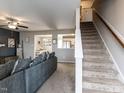 Comfortable living room featuring neutral walls, ceiling fan, and staircase to upper level at 258 Denning Farms Ln, Benson, NC 27504