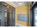 Interior foyer featuring secure mailboxes, tile flooring, decorative lighting, and the front door, offering security at 2810 Bedford Green Dr # 300, Raleigh, NC 27604