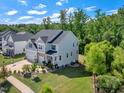 Stunning aerial view of this two-story home featuring a manicured lawn and beautifully landscaped backyard at 2981 Thurman Dairy Loop, Wake Forest, NC 27587