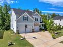Charming two-story home features a basketball court in driveway, well-manicured landscaping, and attached garage at 2981 Thurman Dairy Loop, Wake Forest, NC 27587