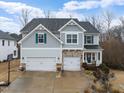 Charming two-story home featuring a two-car garage, landscaped yard, and a cozy front porch at 2981 Thurman Dairy Loop, Wake Forest, NC 27587