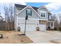 Charming two-story home featuring a two-car garage and a basketball hoop on the driveway at 2981 Thurman Dairy Loop, Wake Forest, NC 27587