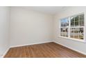 Bright bedroom featuring a large window and sleek wood flooring for a modern touch at 3020 Buttonwood Ln, Clayton, NC 27520