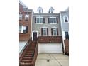 Charming townhouse with a two-car garage, brick accents, and well-maintained landscaping at 3123 Hudson Hill Ln, Raleigh, NC 27612