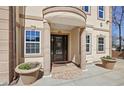 Home's front entrance has elegant columns, a detailed door and an inviting tiled walkway at 318 W Lillington St, Angier, NC 27501